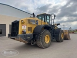 Used Loader under cloudy sky